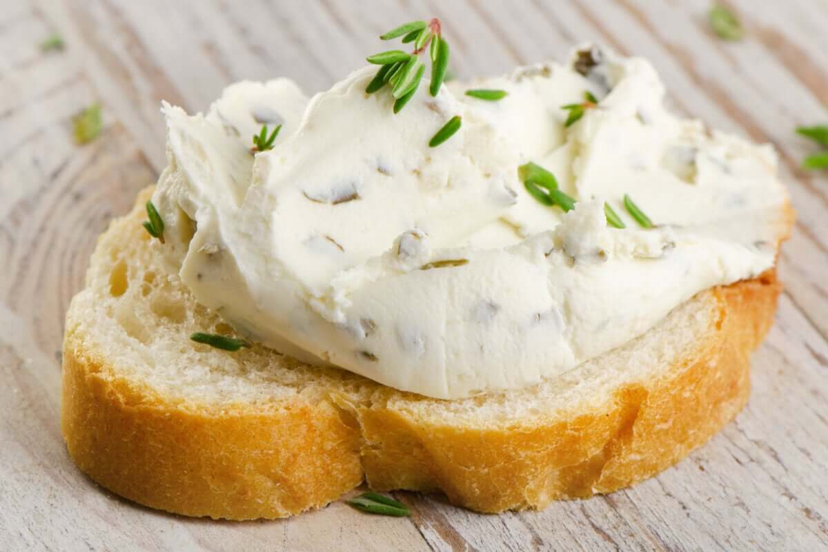 A slice of toast with cream cheese.