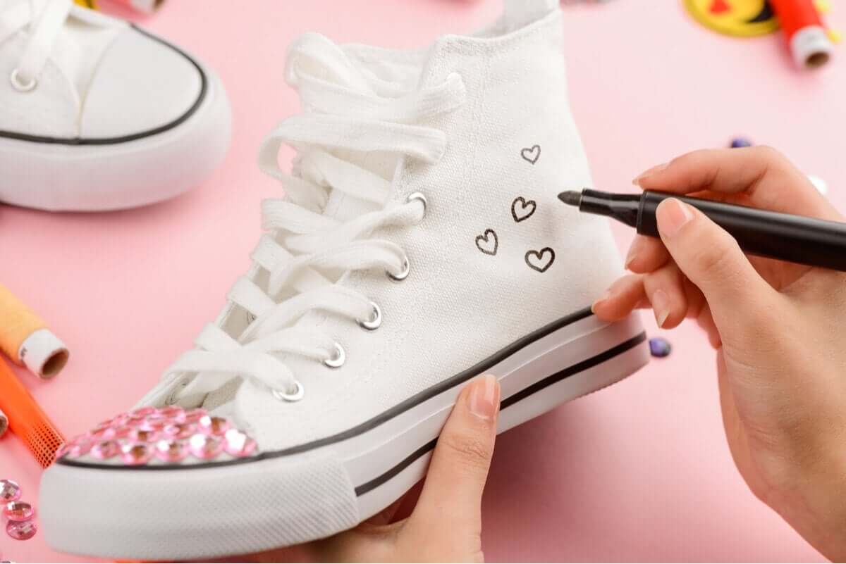 A person customizing her sneakers.