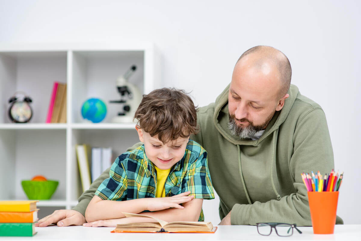 A father doing homework with his son.