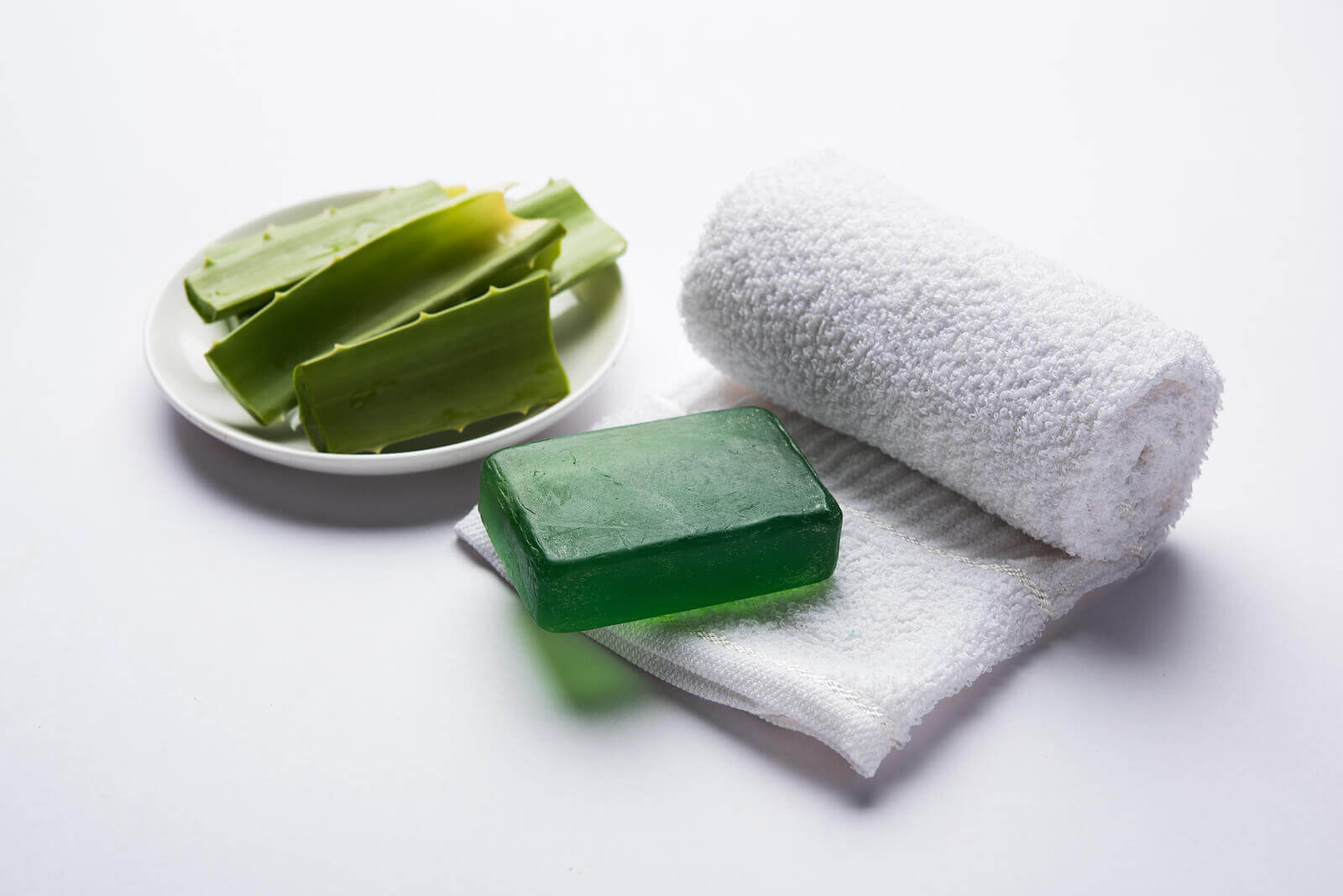 Aloe pieces, aloe soap, and a white towel.