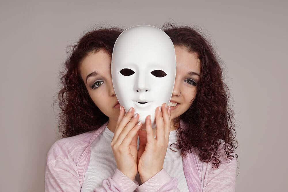 En bipolar kvinde med maske og to ansigter
