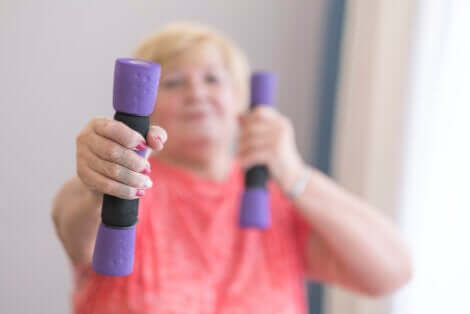A woman exercising with weights.