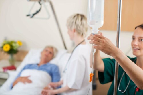 A woman setting up an IV line.