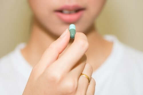 A woman about to take a pill.