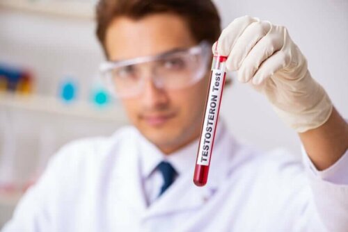 A lab technician holding a vial.