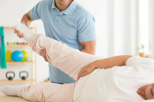 A physiotherapist helping a patient.
