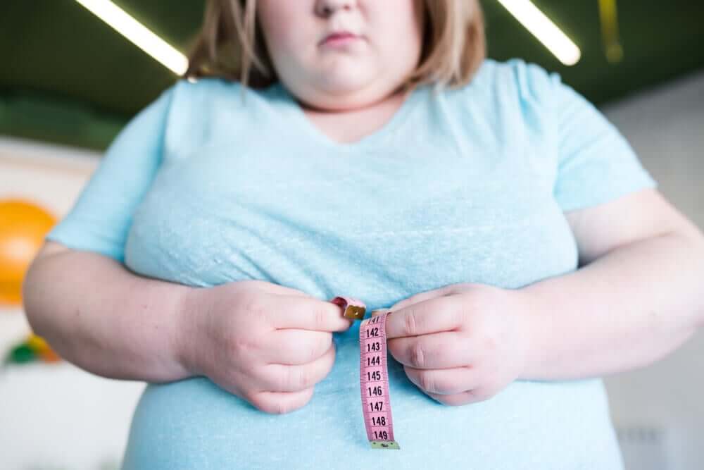 A woman measuring her waist