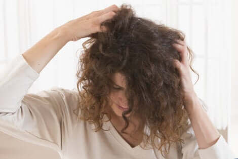 A woman scratching her head.