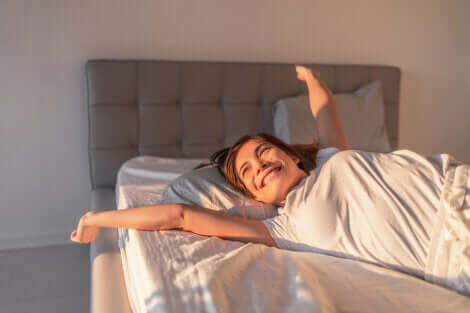 A woman waking up happy.
