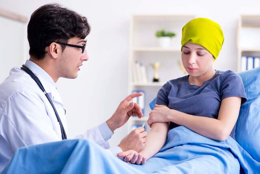 A doctor preparing to give a cancer patient an injection.