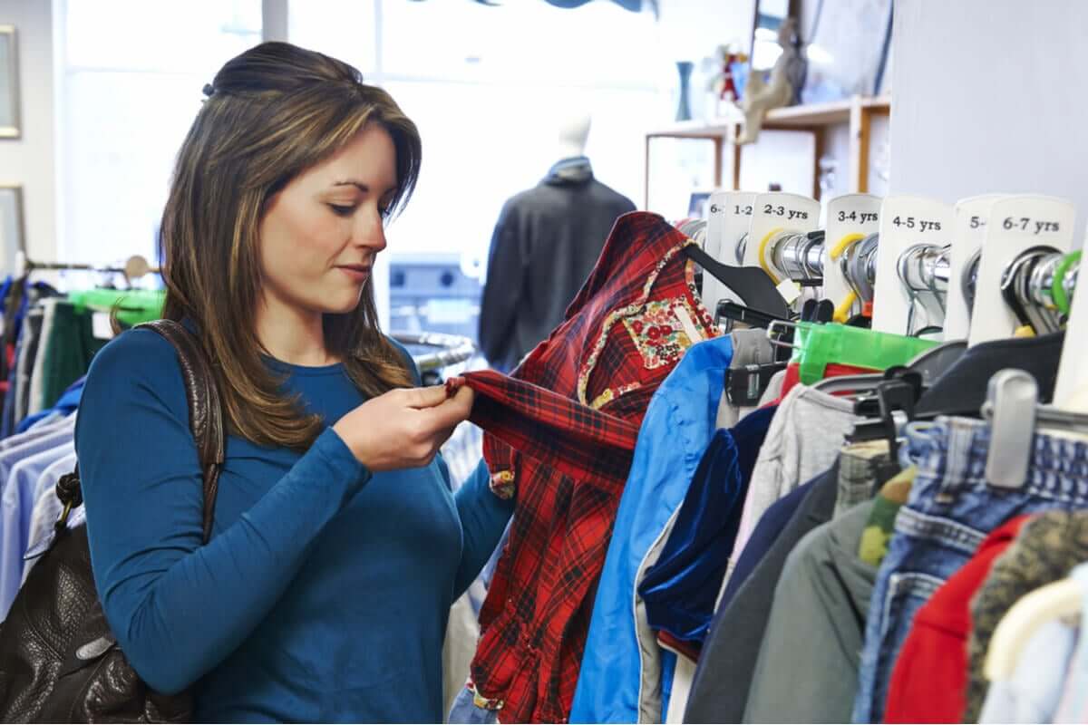 A woman shopping for second hand clothes.