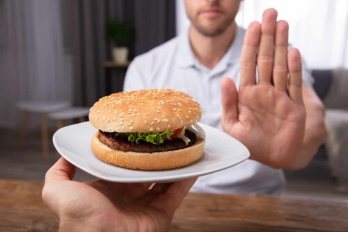 A man rejecting a hamburger.