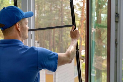 A person installing a screen.
