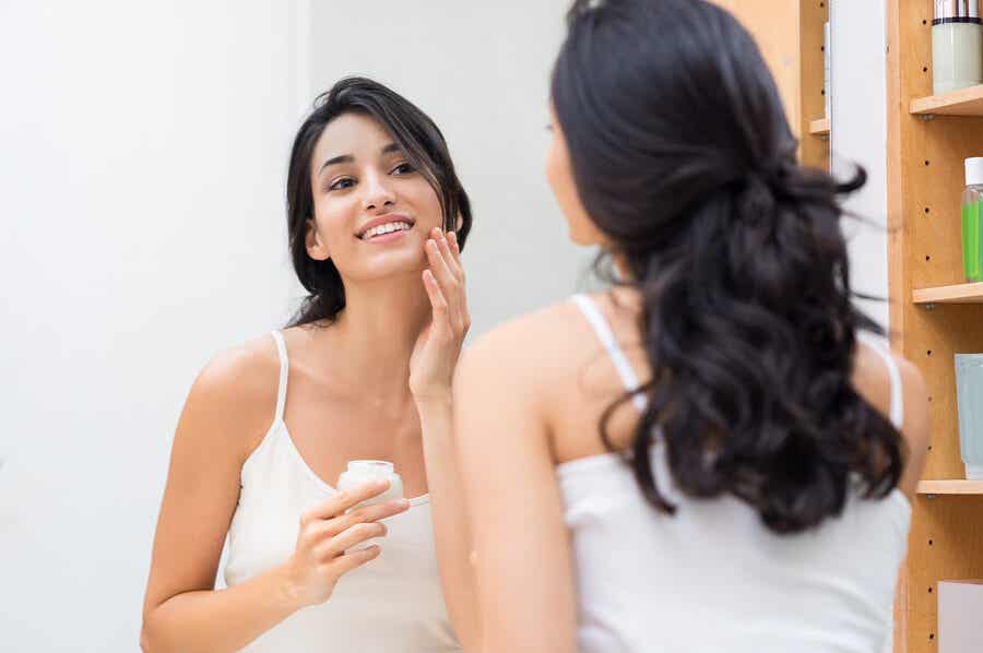 Kosmetikroutine - Eine Frau trägt Gesichtscreme auf