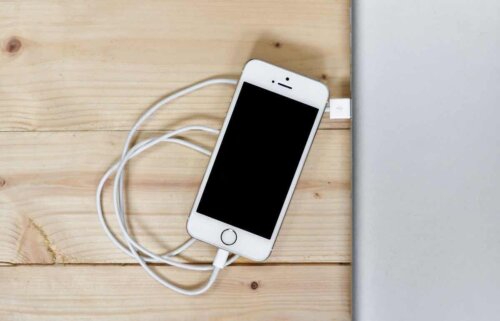 A cell phone with a charger.