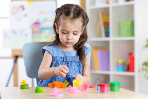 A girl playing with plasticine.