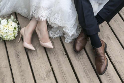 The shoes of a bride and groom.