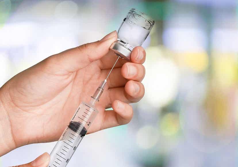 A doctor preparing an injection.