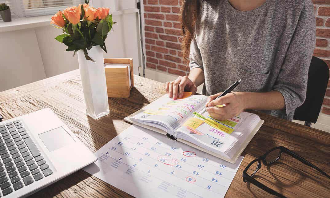 A woman writing in her planner.