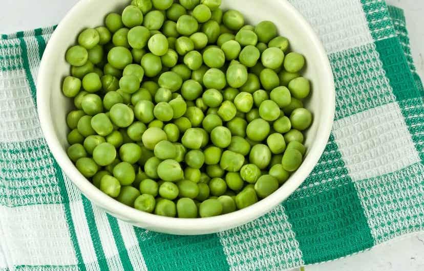 A bowl of fresh green peas.