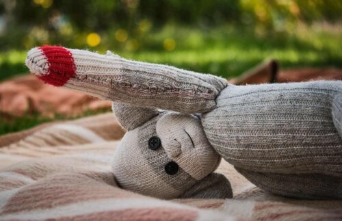 little toy doll made from sock on its head