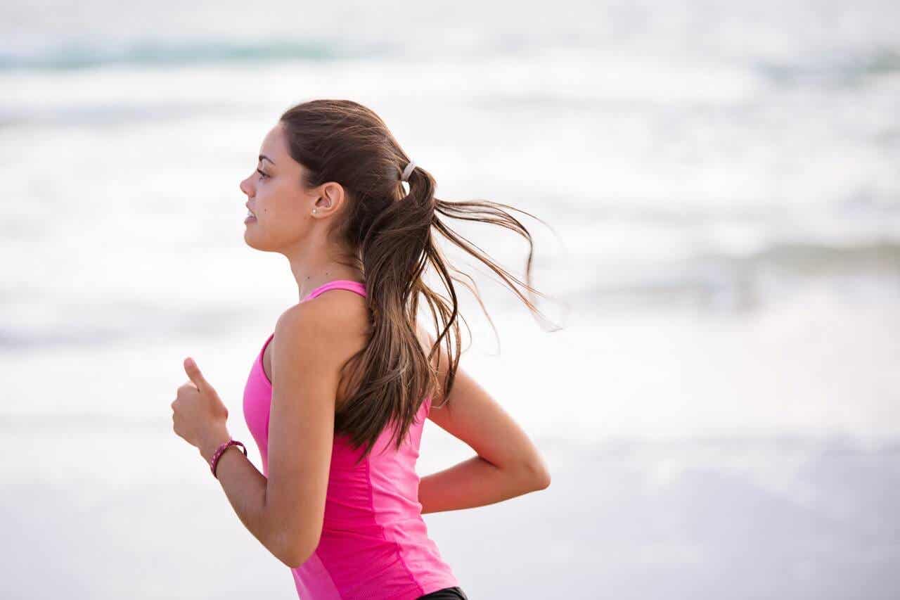 A woman running along the beach.