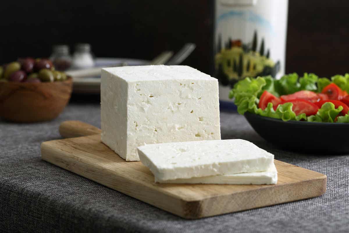 μπλοκ τυρί φέτα σε ξύλο κοπής σε μια κουζίνα