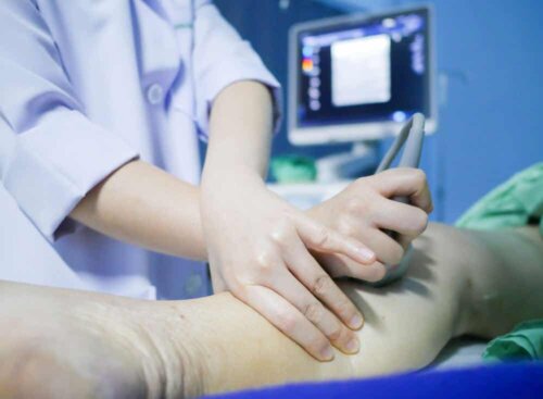 A doctor massaging a leg.