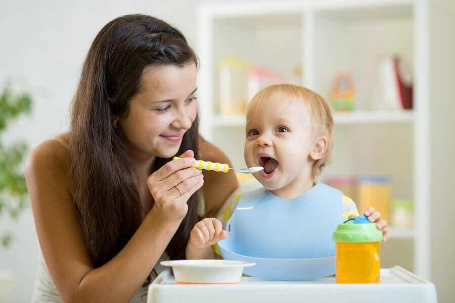 A mother feeding her toddler
