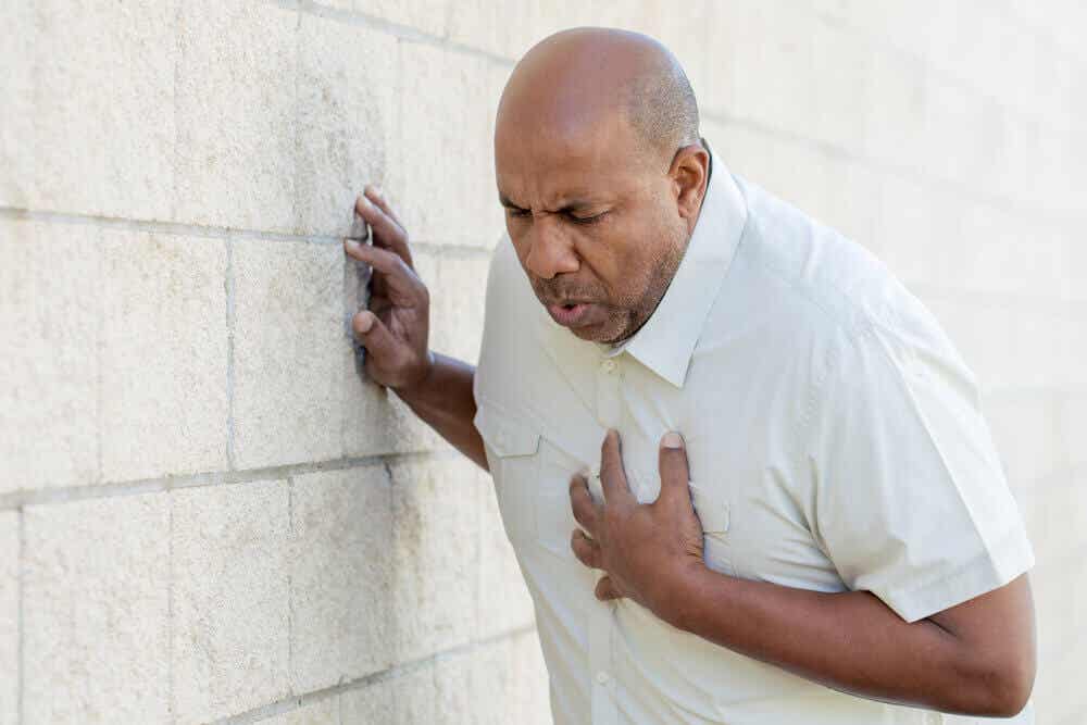 A man with his hand over his chest.